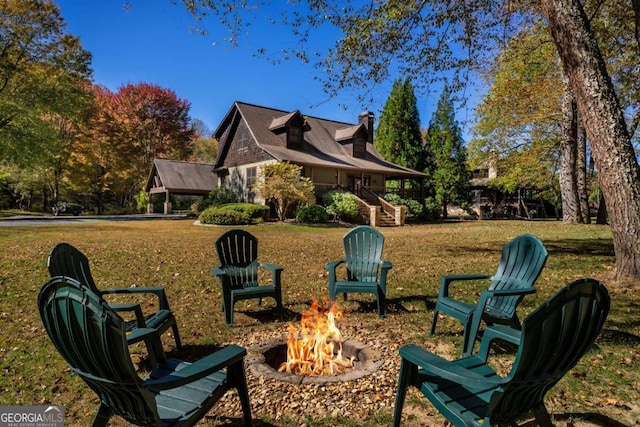 2778 Kelly Ln, Hiawassee, GA 30546 - back of property featuring a fire pit, a yard, a chimney, and stairs
