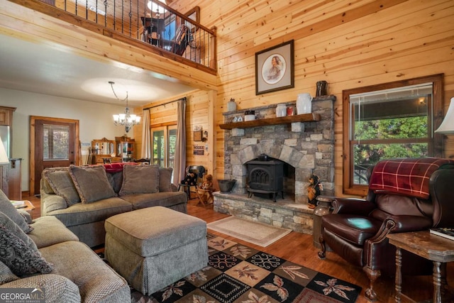 2778 Kelly Ln, Hiawassee, GA 30546 - living area with a chandelier, wood finished floors, plenty of natural light, wood walls, and a wood stove