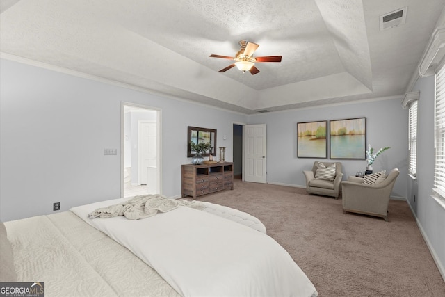 carpeted bedroom featuring a raised ceiling, visible vents, a ceiling fan, baseboards, and a textured ceiling