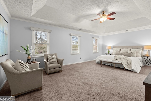 bedroom featuring a tray ceiling, a textured ceiling, carpet flooring, and multiple windows