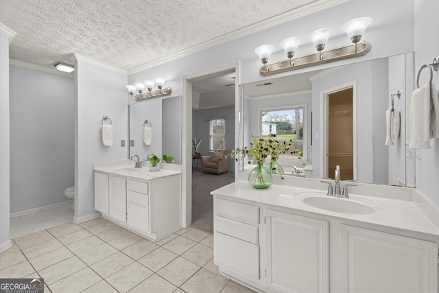bathroom featuring two vanities, tile patterned floors, toilet, and a sink