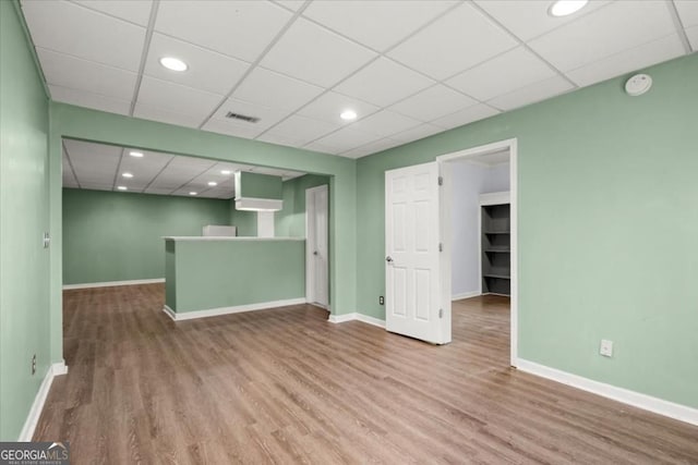 unfurnished living room with recessed lighting, wood finished floors, visible vents, and baseboards