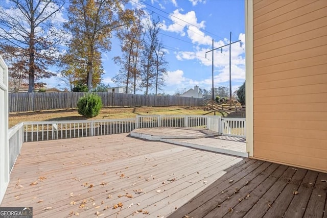 deck with a fenced backyard