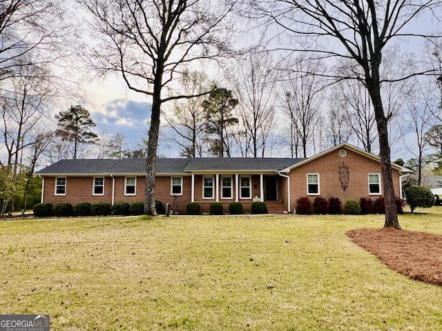 single story home featuring a front lawn and brick siding