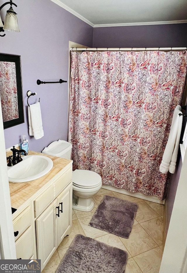 bathroom featuring toilet, vanity, curtained shower, ornamental molding, and tile patterned flooring