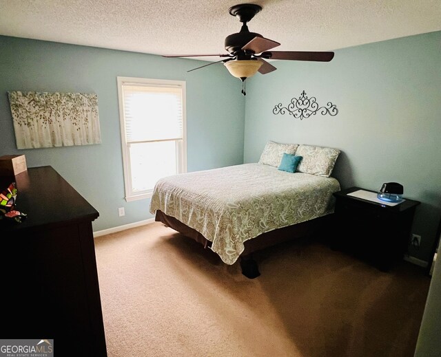 carpeted bedroom with baseboards, ceiling fan, and a textured ceiling