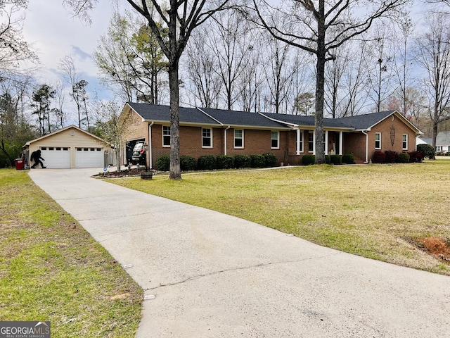 single story home featuring an outdoor structure, brick siding, and a front yard