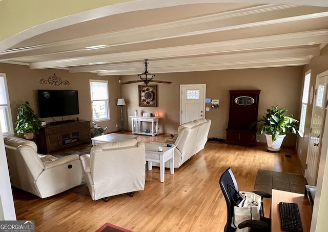 living room featuring beam ceiling and wood finished floors