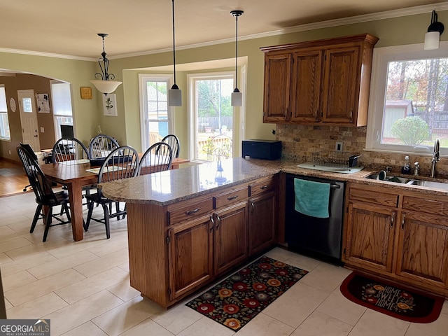 kitchen featuring a peninsula, dishwasher, plenty of natural light, and a sink