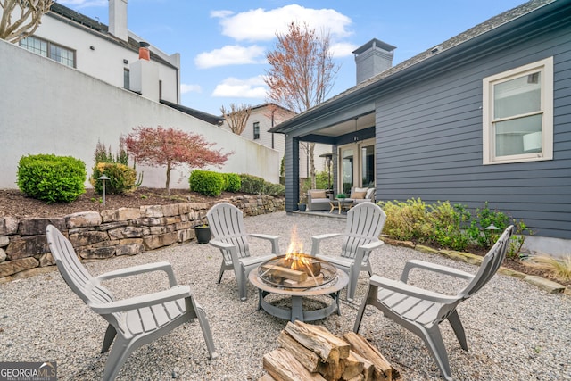 view of patio / terrace featuring a fire pit and fence