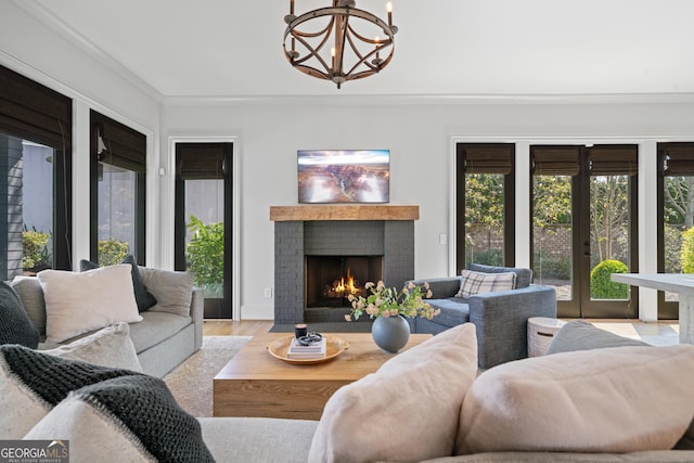 sunroom featuring french doors and a chandelier