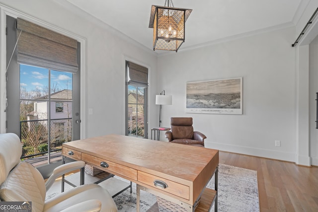 office with a chandelier, healthy amount of natural light, wood finished floors, baseboards, and crown molding