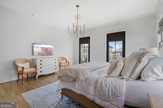 bedroom featuring crown molding, a chandelier, and light wood-style floors