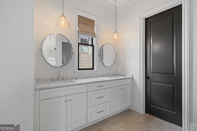 bathroom featuring double vanity, marble look tile flooring, and ornamental molding