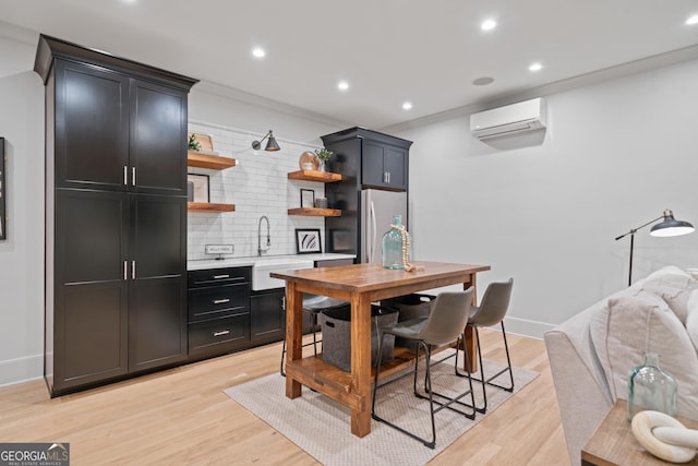 kitchen featuring fridge, a sink, a wall mounted AC, open shelves, and tasteful backsplash