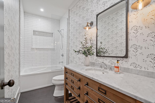 bathroom featuring wallpapered walls, tile patterned floors, toilet, vanity, and shower / bathtub combination