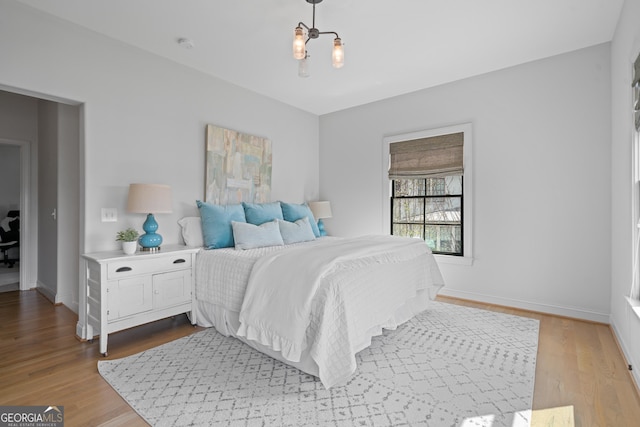 bedroom with wood finished floors and baseboards