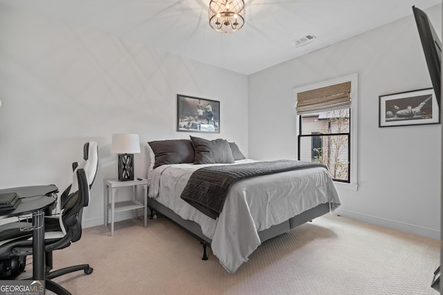 bedroom featuring light colored carpet, baseboards, and an office area
