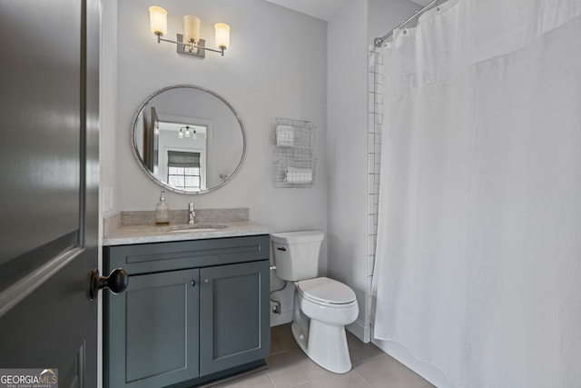 bathroom featuring tile patterned floors, toilet, vanity, and curtained shower