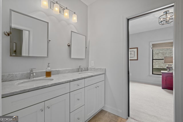 bathroom featuring double vanity, baseboards, and tile patterned flooring