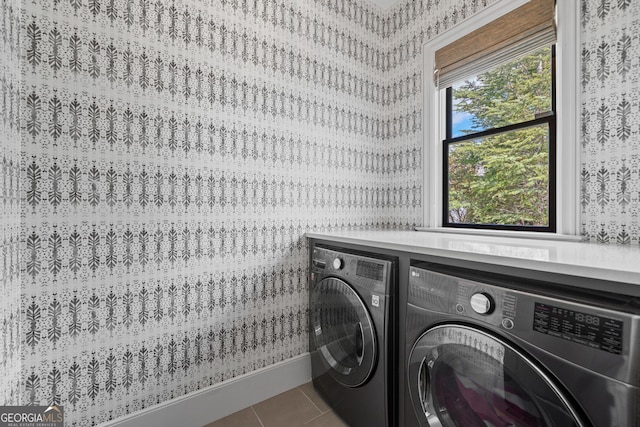 laundry area with washer and dryer, wallpapered walls, and tile patterned flooring