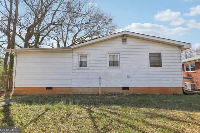 view of home's exterior featuring crawl space, a yard, and cooling unit