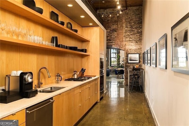 kitchen featuring open shelves, a high ceiling, a sink, appliances with stainless steel finishes, and concrete flooring