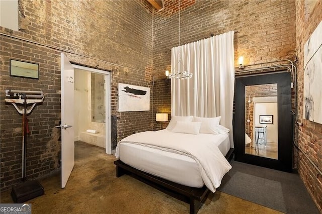 bedroom featuring a high ceiling and brick wall