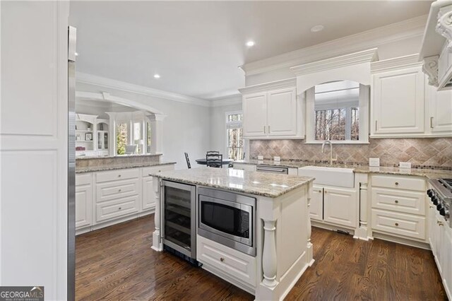 kitchen with appliances with stainless steel finishes, white cabinets, backsplash, and recessed lighting
