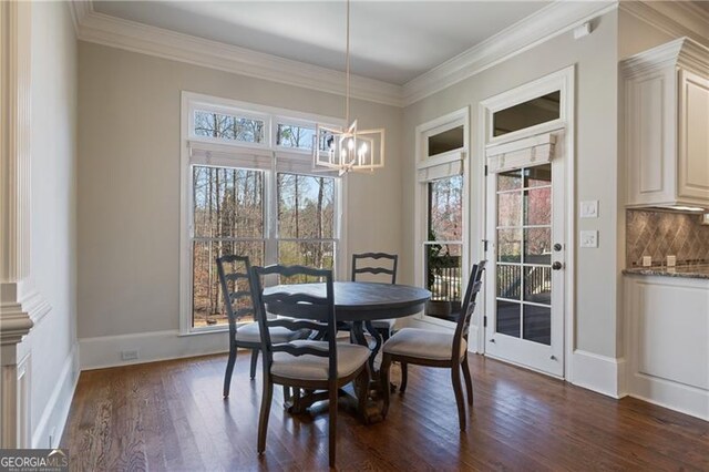 dining room featuring crown molding, baseboards, a notable chandelier, and dark wood-style floors