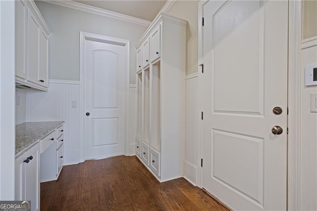 mudroom with crown molding, wainscoting, and dark wood-style floors