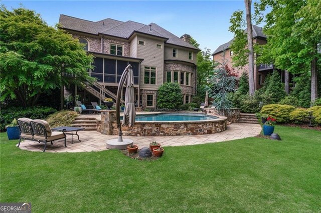 rear view of house featuring stairway, a yard, a patio area, and a sunroom