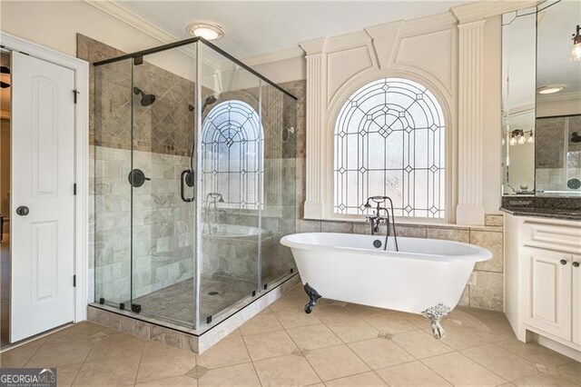 bathroom featuring ornamental molding, a soaking tub, and a shower stall