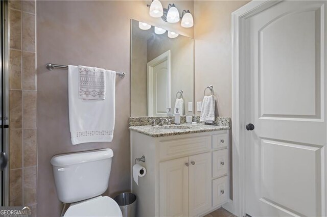 full bathroom with toilet and vanity