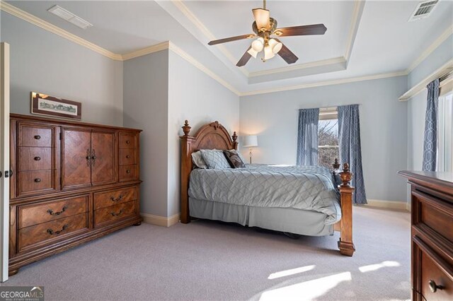 bedroom with crown molding, a raised ceiling, multiple windows, and light colored carpet