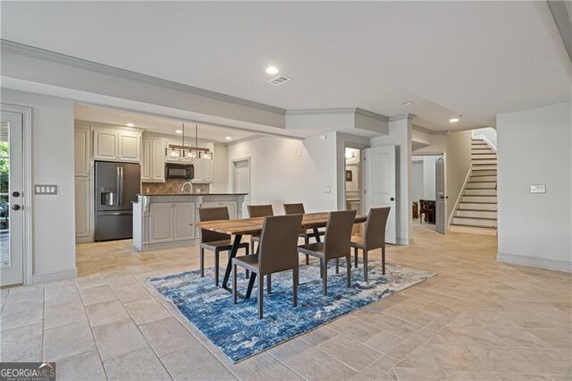 dining space with recessed lighting, stairs, crown molding, and baseboards