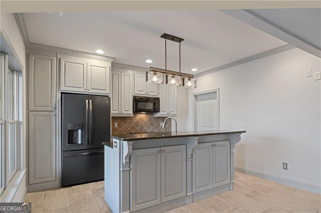 kitchen featuring recessed lighting, dark stone countertops, backsplash, black appliances, and hanging light fixtures