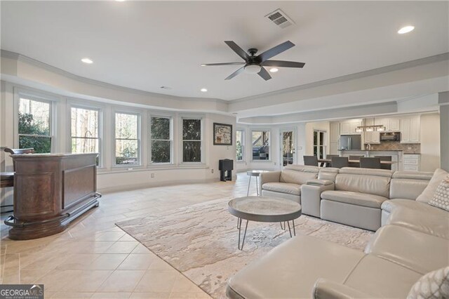 living area featuring visible vents, a ceiling fan, crown molding, and recessed lighting