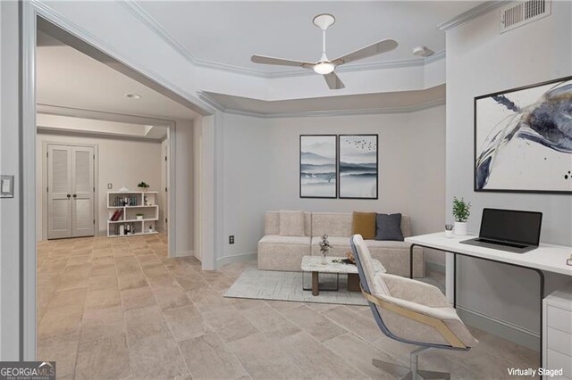 office area with a raised ceiling, a ceiling fan, baseboards, visible vents, and ornamental molding