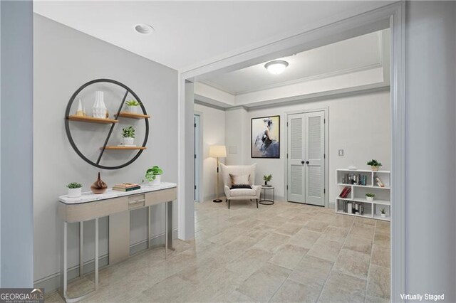 living area featuring stone finish floor and a tray ceiling