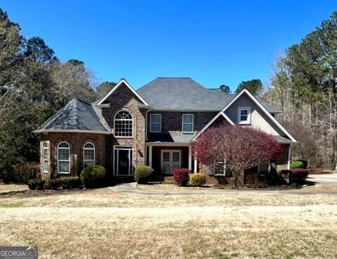 2973 Red Fox Dr, Haddock, GA 31033 - view of front facade featuring french doors and a front yard