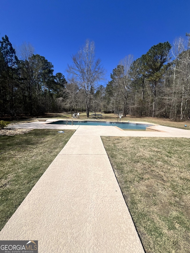 2973 Red Fox Dr, Haddock, GA 31033 - outdoor pool with a lawn and view of scattered trees