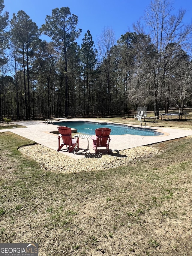 2973 Red Fox Dr, Haddock, GA 31033 - swimming pool with a yard and a patio area