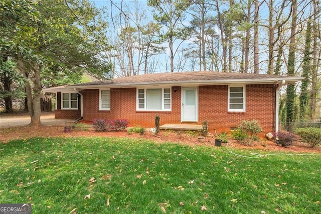 ranch-style home featuring brick siding and a front lawn