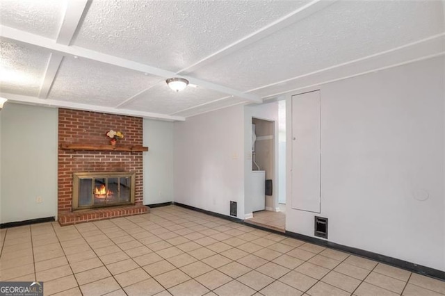 unfurnished living room featuring baseboards, a brick fireplace, a textured ceiling, and light tile patterned floors