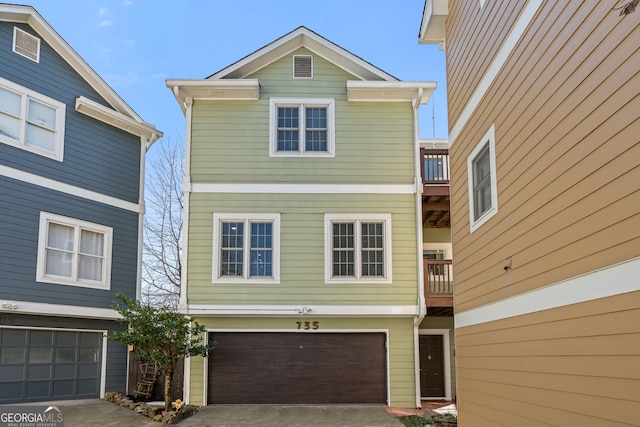 view of front of home with a balcony, a garage, and driveway