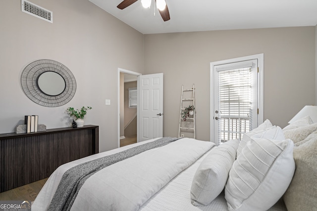 bedroom with visible vents, wood finished floors, a ceiling fan, and vaulted ceiling