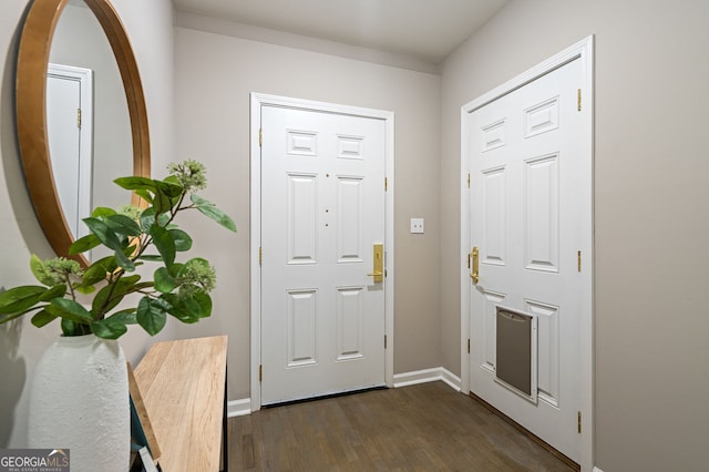 foyer with baseboards and dark wood-style floors