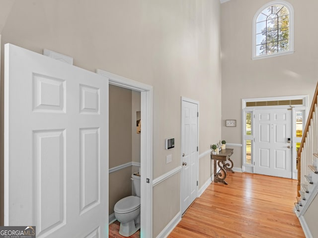 152 Vinings Lake Ct SW, Mableton, GA 30126 - entrance foyer featuring light wood finished floors, stairs, a high ceiling, and baseboards