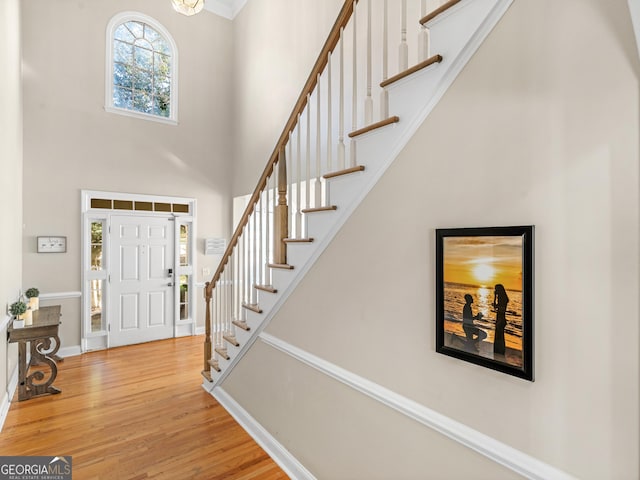 152 Vinings Lake Ct SW, Mableton, GA 30126 - foyer with stairs, wood finished floors, a towering ceiling, and baseboards